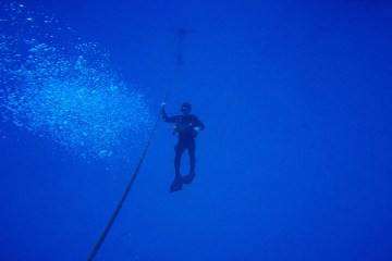 Scuba diver underwater in distance